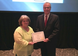 Joyce Beck receives a certificate to recognize her 34 years of service from Alabama Nursing Home Association Executive Director Bill O'Connor at Alabama's Best Practices 2014.