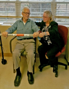 Lynwood Healthcare & Rehab Center Administrator Laura Saxon assists resident Thomas Bosarge with therapy.