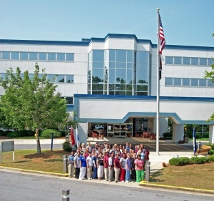 Staff members stand in front of the main entrance to Bill Nichols State Veterans Home in Alexander City.