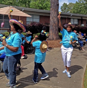 Talladega Health & Rehab - Rehab Select Resident Services staff members Dorothy Thomas, Rashema Morris and Shalanda Roberson lead the Mexican hat dance.