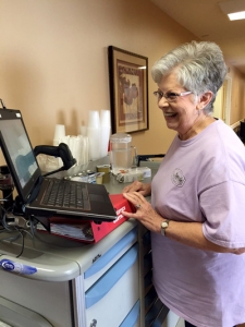 Licensed Practical Nurse Charlene Guest has spent her entire 48-year career at Hanceville Nursing & Rehab Center. In this photo, Ms. Guest prepares to update electronic medical records using a laptop connected to a medicine cart.