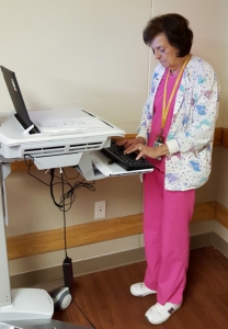 Fran Howell has seen a lot of changes over the course of her 54-year career as a Licensed Practical Nurse. In this photo, Ms. Howell updates electronic medical records at Cypress Cove Center.