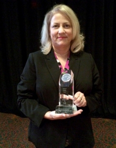 Cottage of the Shoals Administrator Cheryl Baker with the AHCA Silver Quality Award.