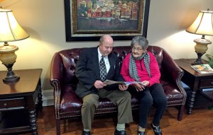 Heritage Health Care & Rehab Administrator George Jackson reads a magazine with resident Polly Kyles.