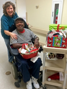 Janet Daughdrill and Ashland Place resident Daniel Coleman. Mr. Coleman received Christmas gifts from the Angel Tree program.