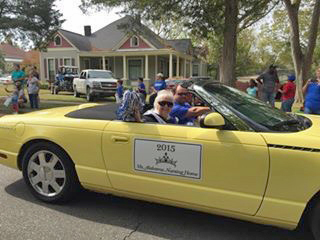 Ms. Alabama Nursing Home Sylvia Holland waves to the crowd while riding in the Christmas on the River Parade in Demopolis.