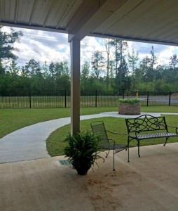 Covered patio, walking track in the private courtyard for Countryside Garden Memory Care Unit at Aliceville Manor Nursing Home.