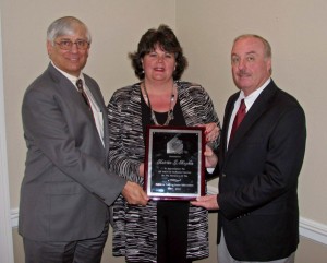 Katrina Magdon is recognized for 25 years of service to ANHA by 2012 ANHA Vice-President Richard Brockman, left, and President Eddie Jackson.