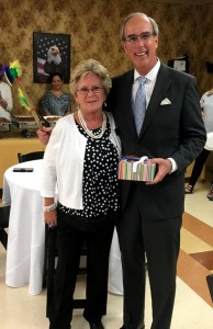 Lynwood Administrator Laura Saxon presents Mobile Mayor Sandy Stimpson with a special gift to make him an honorary member of Lynwood's Dreamcatcher Tribe.