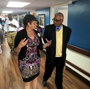 Fairview Health & Rehab Center Administrator Dianne Webb gives Jefferson County Commissioner George Bowman a tour of the Life Engagement Unit.