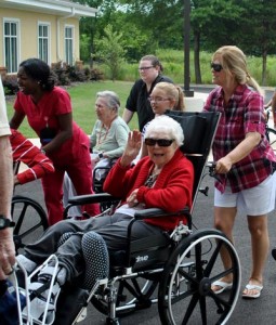 Resident LaVerne Harmon waves to the camera during move-in day at Regency Health Care & Rehab Center in Huntsville.