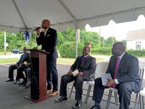 Magnolia Haven Administrator Travis Harper speaks at the ribbon cutting ceremony. Also pictured is Bishop Alvin Howard, left, and Kevin Ball of Ball HealthCare Services.