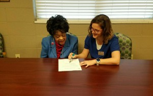 Crowne Health Care of Mobile resident Ruth Vaughn learns about the dental program from Social Services Designee Keri Jones.