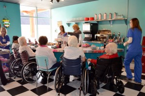 Residents surround the soda fountain at Bibb Medical Center Nursing Home's 50s Diner.